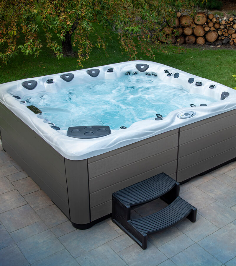 A paver patio can be a perfect spot for a large hot tub like this Legend Series spa