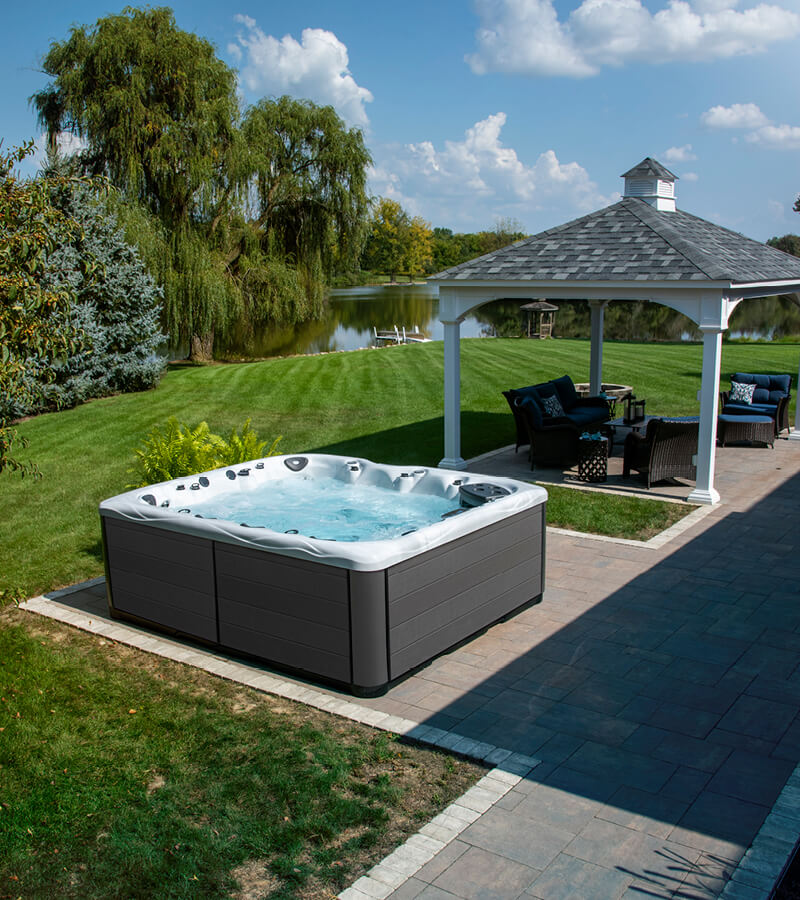 A hot tub and pergola create distinct spaces for relaxation and entertaining